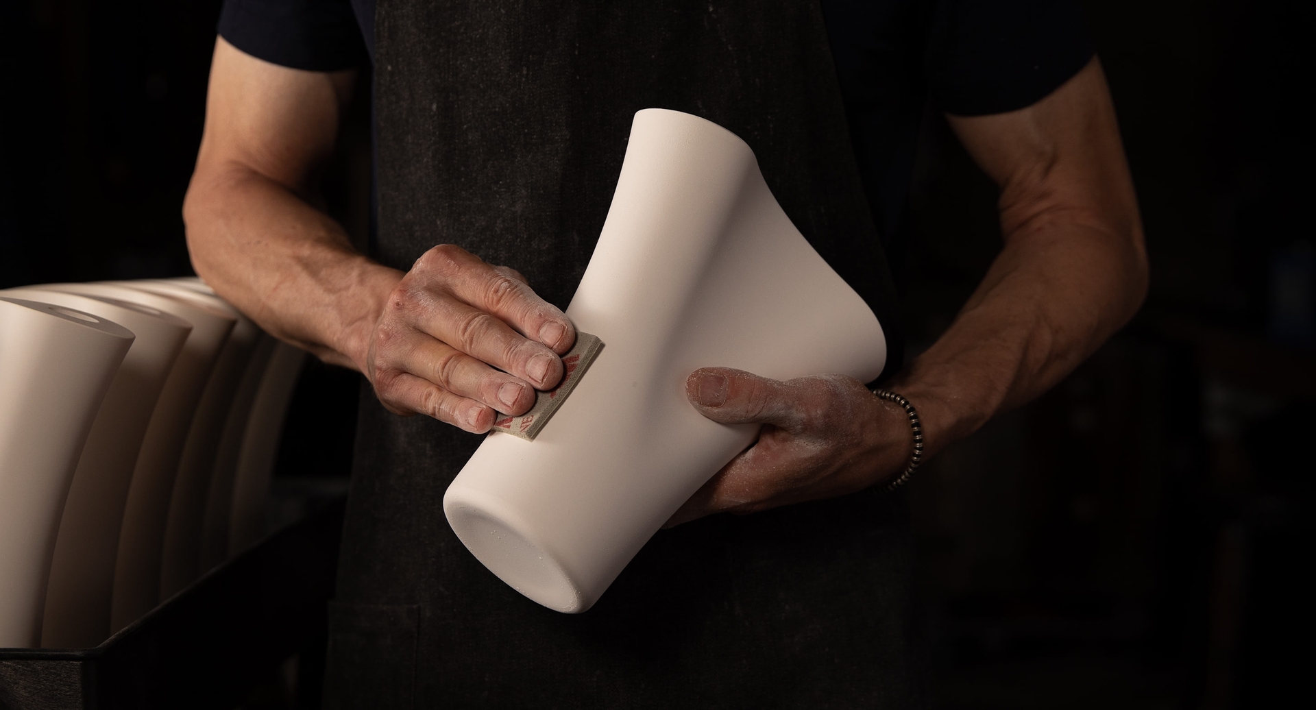 Person sanding contemporary porcelain water pipe